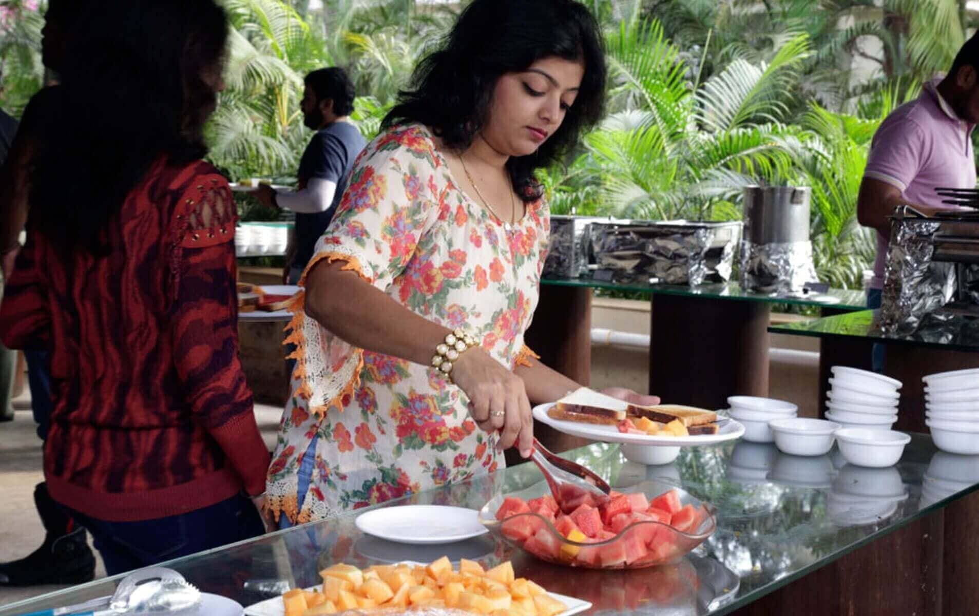 Chef preparing food at an outdoor live counter buffet at Manas Resort