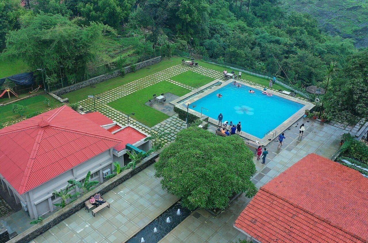 Aerial view of pool and activities at Manas Resort, Igatpuri