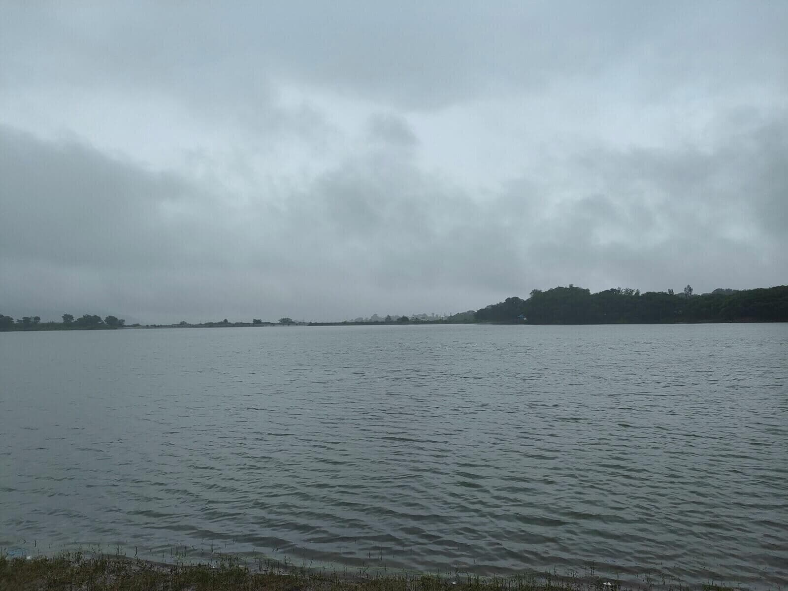 Reservoir and boat against hills