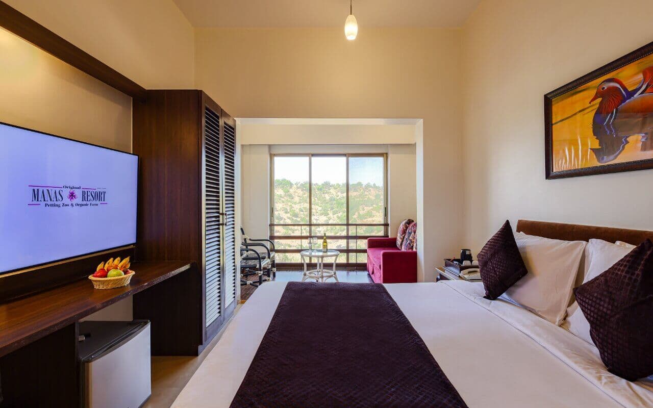 Large windows with nature view in Koi Vista Room, Manas Resort Igatpuri